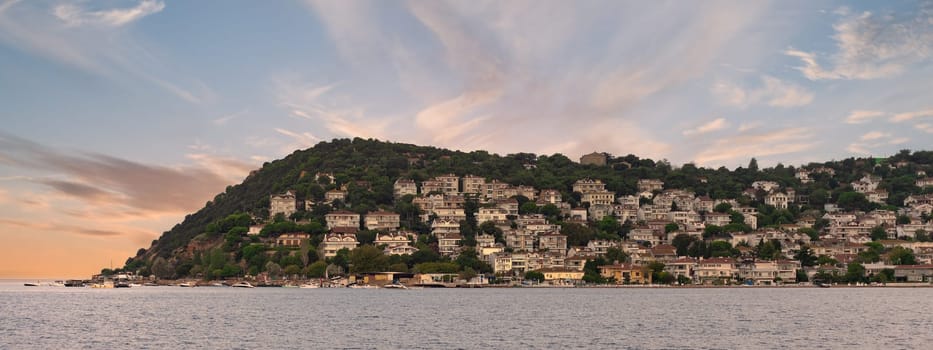Kinaliada Island showcases hillside homes against a stunning sunset, reflecting the charm of Turkish island life