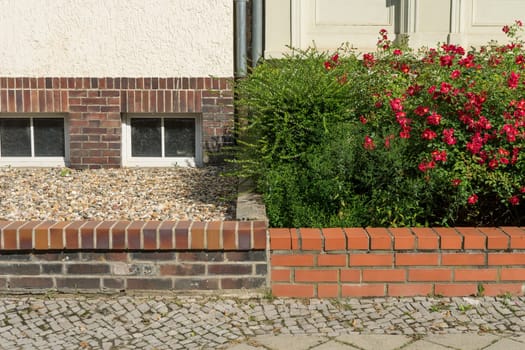 Two front gardens with and without plants in summer