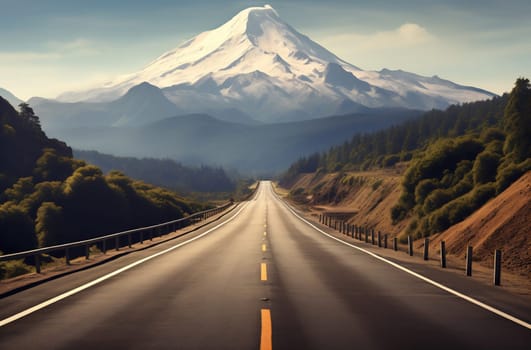 A long, winding road leads towards a majestic snow-capped mountain under a clear sky, surrounded by green hills on either side.