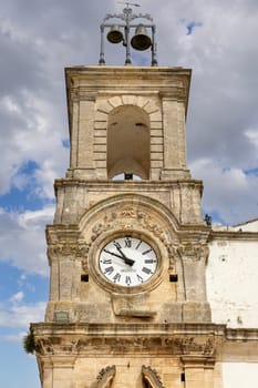 Martina Franca, Italy, Apulia - May 25, 2024: Civic Tower (Torre dell'Orologio) next to University Palace, located in Plebiscito Square (Piazza Plebiscito)