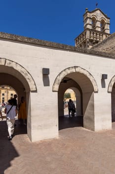 Matera, Italy - May 22, 2024: Bell tower of Mater Domini church and portico Three Arches located in Vittorio Veneto Square
