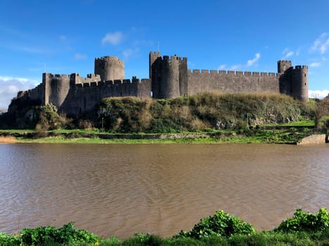 Pembroke Castle - medieval castle in Pembroke, Pembrokeshire, Wales. The castle was the original family seat of the Earldom of Pembroke. A Grade I listed building, it underwent major restoration during the early 20th century.