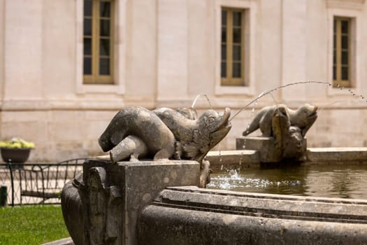 Martina Franca, Italy, Puglia - May 20, 2024: Fountain with dolphins located at Piazza Rome in front of Palazzo Ducale next to St. Stephen's Gate (Porta di Santo Stefano)
