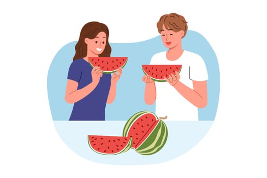 Man and woman eat watermelon, enjoying taste of juicy fruit that relieves thirst in hot weather. Pieces of delicious watermelon from satisfied guy and girl recommend eating organic food