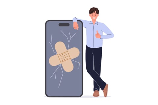 Phone screen repair from man covering cracked display with medical plaster and showing thumbs up. Repairing phone and restoring functionality of gadget yourself after smartphone falls on asphalt