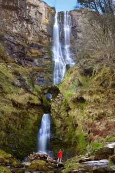 Pistyll Rhaeadr Waterfall in Powys in Wales. Formed by the Afon Disgynfa's falling, in three stages, over a 73m Silurian cliff-face, after which the river is known as the Afon Rhaeadr. Note the natural arch in the middle.