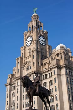 The iconic Liver Building and statue of King Edward VII on the waterfront of the River Mersey in the city of Liverpool in the northwest of England.