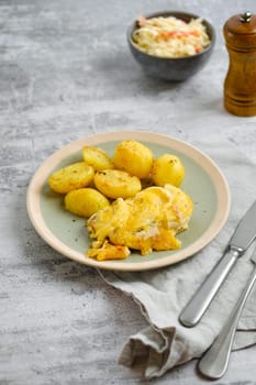 Pork chops with melted cheese topping and roasted potato