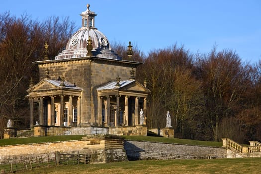 Temple of the Four Winds at Castle Howard - North Yorkshire - England. Castle Howard is a stately home in North Yorkshire, England, 15 miles (24 km) north of York. One of the grandest private residences in Britain, most of it was built between 1699 and 1712 for the 3rd Earl of Carlisle, to a design by Sir John Vanbrugh. It is not a true castle, the word is often used for English country houses constructed after the castle-building era (c.1500) and not intended for a military function. Castle Howard has been the home of the Howard family for more than 300 years.