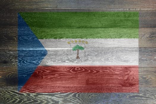 An Equatorial guinea flag on rustic old wood surface background