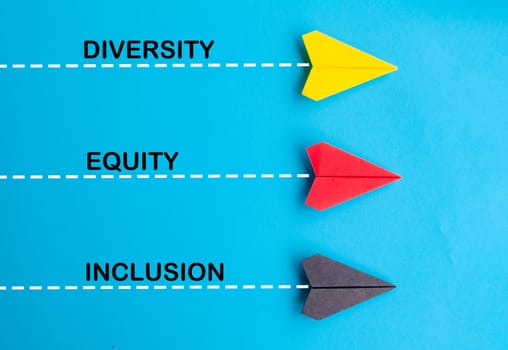 Top view of multicolored paper airplane with text, Diversity, Equity and Inclusion. DE and I concept.