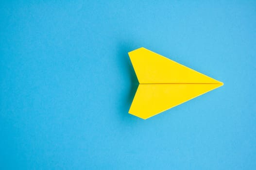 Top view of yellow paper airplane with customizable space for text or ideas.