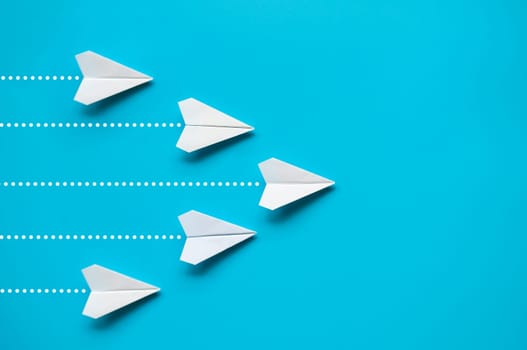 White paper airplane leading the rest of the white paper airplanes with customizable space for ideas or text. Leadership concept.