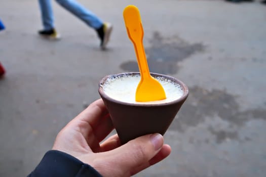 A small clay pot filled with Juju Dhau, king of yoghurt, a traditional type of curd, yoghurt from Bhaktapur, Nepal 2022