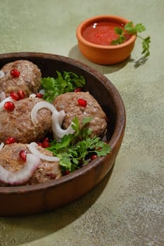 Close-up view of traditional Georgian fried beef cutlets - Apkhazura in clay pot
