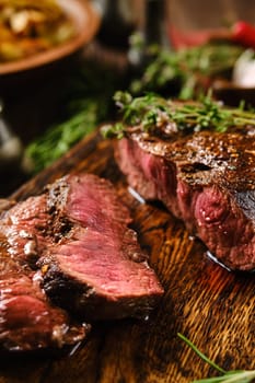 Close-up view of juicy grilled top blade beef steak cut on slices