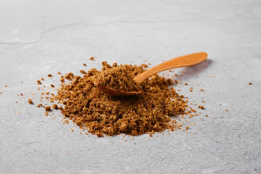 Traditional Georgian svanetian salt and wooden spoon on concrete background