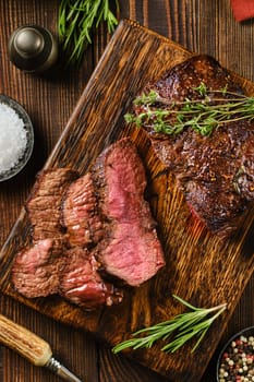 Close-up overhead view of grilled top blade beef steak cut on slices