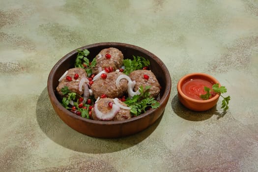 Fried beef or lamb patties wrapped in fat gut - Apkhazura in clay pot and small bowl with ajika sauce