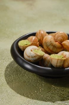Close-up view of Escargot snails stuffed with butter, spice and cilantro