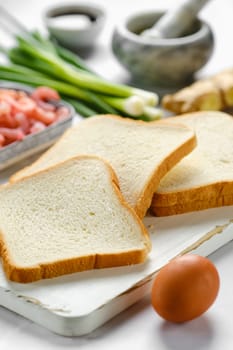 Close-up view of slices of bread for toasts and ingredients