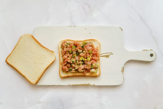 Overhead view of making club sandwich with spicy shrimps