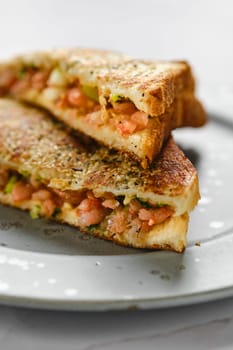 Close-up view of club sandwich with spicy shrimps on a plate