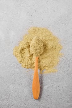 Overhead view of utskho suneli powder and wooden spoon