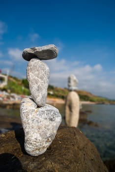 balanced stones on the rocks of the sea
