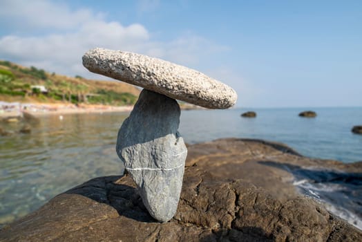 balanced stones on the rocks of the sea