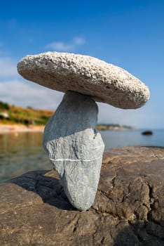 balanced stones on the rocks of the sea