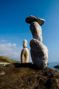 balanced stones on the rocks of the sea