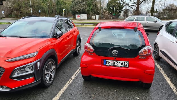 VELBERT, NRW, GERMANY - JANUARY 20, 2022: Hyundai Kona small SUV car, with new aluminum rims with red stripes and Toyota Aygo