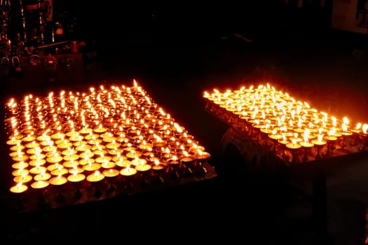 Many butter lamps, candles enlighten the night at the Boudhanath Stupa, Kathmandu, Nepal 2022