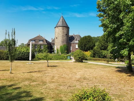 RATINGEN, NRW, GERMANY - AUGUST 22, 2018: View of the mansion, from Linnep Castle. Old moated castle, side view to the castle on a sunny day.