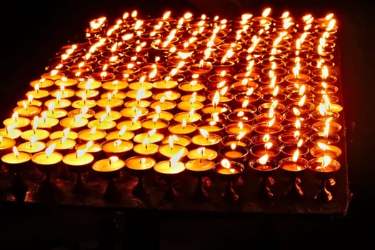 Many butter lamps, candles are burning at night at the Boudhanath Stupa in Kathmandu, Nepal 2022