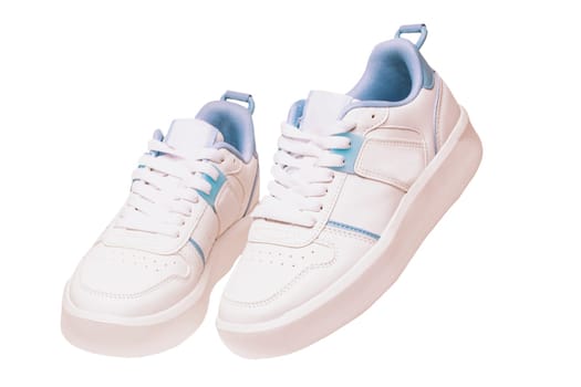 White sneaker. Close-up of a pair white elegant stylish female leather high-heeled sport shoes isolated. Clipping path. Womens shoe fashion. Modern design footwear for workout.