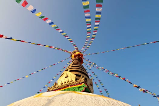 The top of the Swayambhunath Stupa, Temple, decorated with many colorful prayer flags, Kathmandu, Nepal 2022