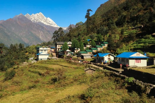 The village of Paiya in the morning sun, the Himalayas can be seen in the background, Mount Everest Basecamp Trek, Nepal 2022