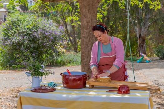 Andalucia, Spain: April 17, 2024: A woman works making Pecorino cheese. Handmade cheese making near Granada, Spain