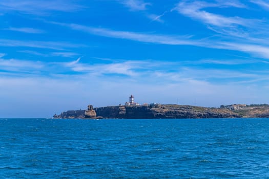 Lighthouse and cliffs of Carvoeiro cape in Peniche, Atlantic coast, Portugal