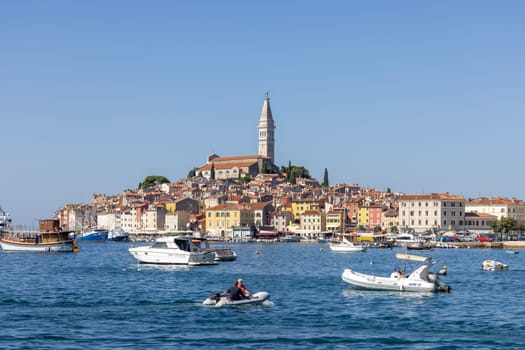 Rovinj, Croatia, Istria - September 29, 2023: Beautiful view from the South port Rovinj over Adriatic Sea to the peninsula with the Old Town and the tower of Saint Euphemia Church