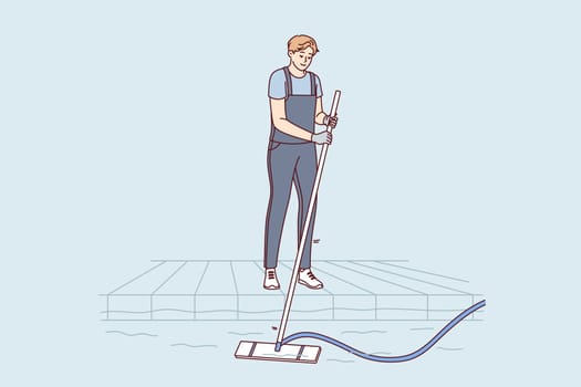 Man pool cleaner uses electric hoover with hose to suck out algae and debris from bottom. Pool cleaner guy enjoys work and achieving perfect results in preparation for swimming season.