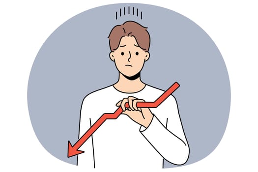 Sad man holds declining chart symbolizing beginning of crisis and financial recession affecting income. Upset guy with red down arrow reports decrease in number of clients or decrease in wages