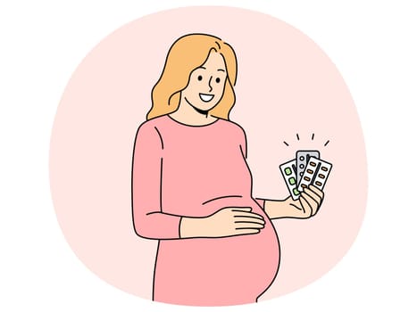 Pregnant woman holds blisters of pills and vitamins to support immunity of baby in womb. Pregnant expectant mother recommends taking useful medicines to get rid of health problems.