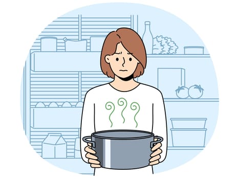Frustrated woman housewife with pot of sour soup, feels bad smell from food spoiled due to violation of sanitary rules. Girl is standing in kitchen and holding stinking soup in bewilderment
