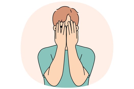 Man closes eyes with hands and peeps, feeling excited in anticipation of surprise or panic after receiving threats. Guy feels insecure and panic, trying to hide from problems that have arisen.