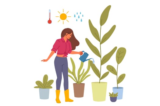 Woman florist grows houseplants in greenhouse, watering flowers with water and fertilizer. Girl from flower shop or greenhouse works as florist, enjoying growing plants to decorate interior of house.