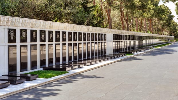 Baku, Azerbaijan - May 6, 2024: Martyrs' Lane, with memorial portraits amidst verdant trees and a serene atmosphere