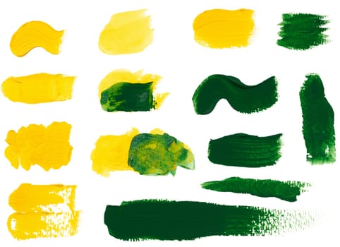 Yellow and green strokes of acrylic paint on a white background